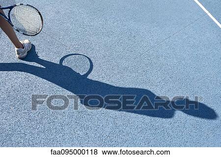 Tennis player standing in tennis court, focus on shadow View Large Photo Image Stock Photo - Tennis player standing in tennis court, focus on shadow. Fotosearch