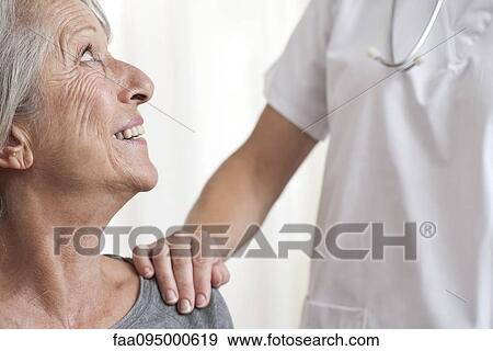 Woman being comforted by healthcare professional, cropped View Large Photo Image Stock Photo - Woman being comforted by healthcare professional, cropped. Fotosearch