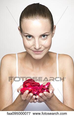 Woman holding rose petals in cupped hands, portrait View Large Photo Image Stock Photo - Woman holding rose petals in cupped hands, portrait. Fotosearch