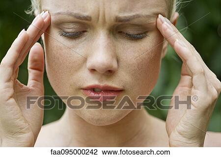 Woman rubbing temples View Large Photo Image Stock Image - Woman rubbing temples. Fotosearch