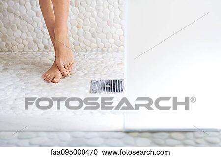 Woman standing in shower, cropped view of feet View Large Photo Image Stock Image - Woman standing in shower, cropped view of feet. Fotosearch