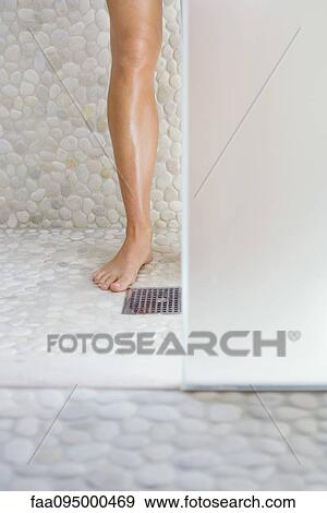Woman standing in shower, cropped view of one leg View Large Photo Image Stock Photo - Woman standing in shower, cropped view of one leg. Fotosearch