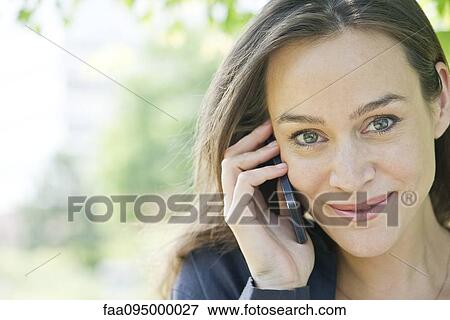 Woman talking on smartphone View Large Photo Image Stock Photo - Woman talking on smartphone. Fotosearch