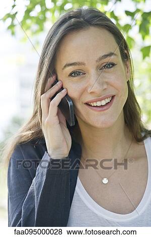 Woman talking on smartphone View Large Photo Image Stock Photo - Woman talking on smartphone. Fotosearch