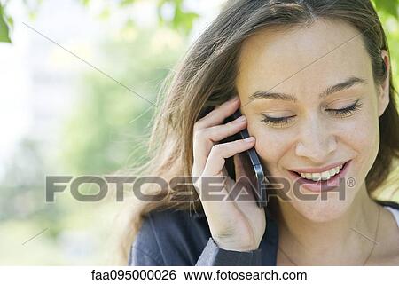 Woman talking on smartphone View Large Photo Image Stock Photograph - Woman talking on smartphone. Fotosearch