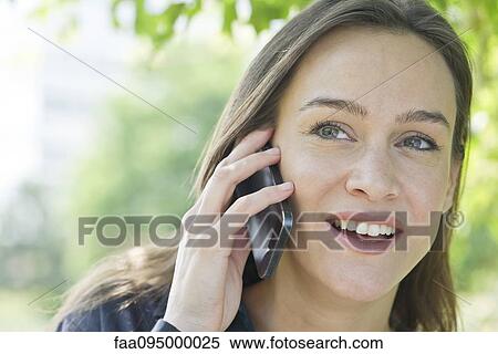 Woman talking on smartphone View Large Photo Image Stock Photography - Woman talking on smartphone. Fotosearch