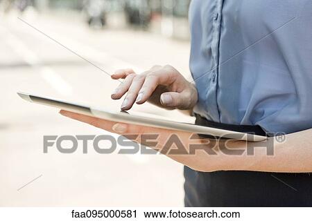 Woman using digital tablet View Large Photo Image Stock Image - Woman using digital tablet. Fotosearch