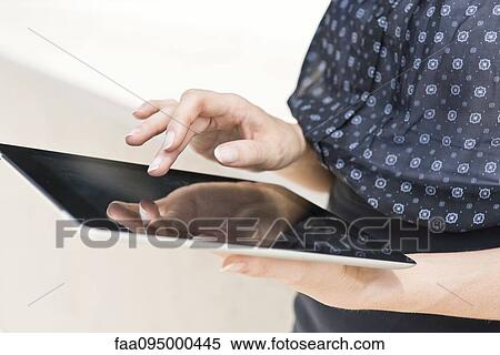 Woman using digital tablet View Large Photo Image Stock Photography - Woman using digital tablet. Fotosearch