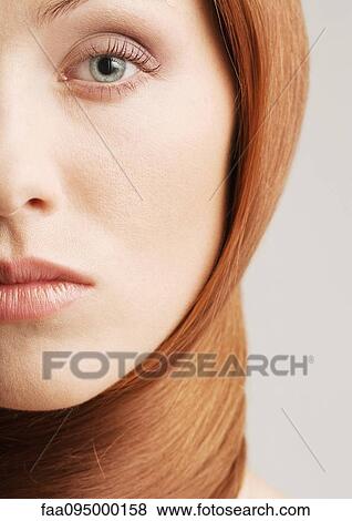 Stock Photo - Woman with hair wrapped around neck, close-up portrait. Fotosearch