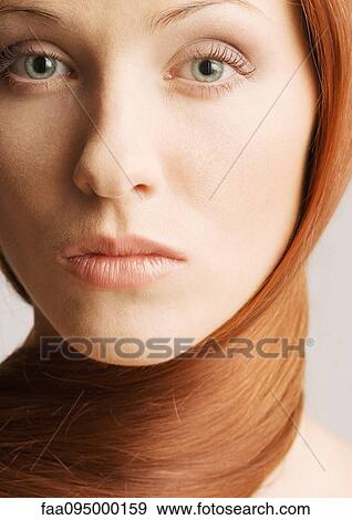Stock Photo - Woman with hair wrapped around neck, close-up portrait. Fotosearch