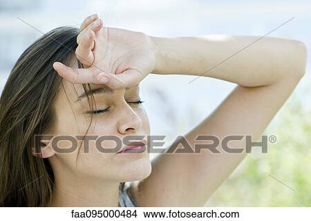 Woman with hand on forehead View Large Photo Image Picture - Woman with hand on forehead. Fotosearch