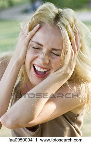 Woman with head in hands, screaming View Large Photo Image Stock Image - Woman with head in hands, screaming. Fotosearch