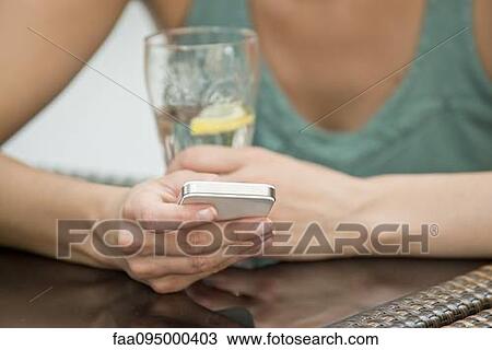 Stock Image - Woman with smartphone. Fotosearch