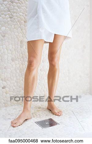Woman wrapped in towel standing in shower-room, low section View Large Photo Image Stock Photo - Woman wrapped in towel standing in shower-room, low section. Fotosearch