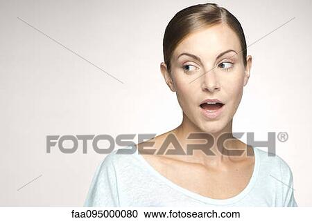 Young woman looking away with mouth open in surprise, portrait View Large Photo Image Stock Image - Young woman looking away with mouth open in surprise, portrait. Fotosearch