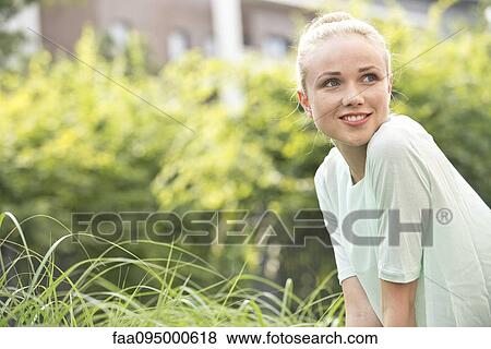 Stock Photo - Young woman outdoors, portrait. Fotosearch