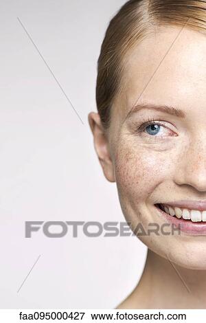 Young woman smiling and looking away thoughtfully, portrait View Large Photo Image Stock Photo - Young woman smiling and looking away thoughtfully, portrait. Fotosearch