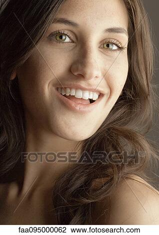 Young woman smiling at camera, portrait View Large Photo Image Stock Image - Young woman smiling at camera, portrait. Fotosearch