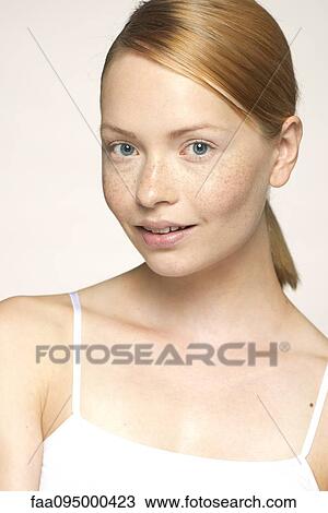 Stock Image - Young woman smiling, portrait. Fotosearch