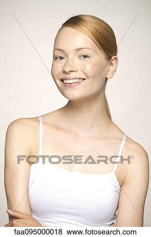 Young woman smiling, portrait View Large Photo Image Stock Photo - Young woman smiling, portrait. Fotosearch