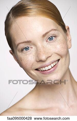 Stock Photo - Young woman smilling cheerfully, portrait. Fotosearch