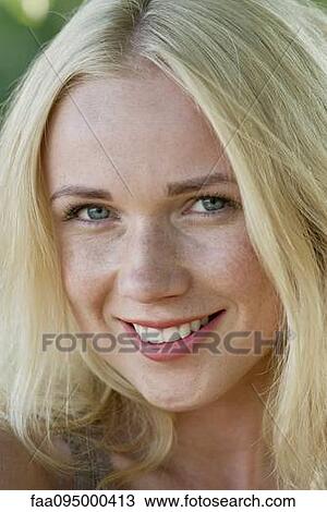 Stock Image - Young woman with blonde hair. Fotosearch
