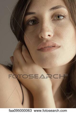 Young woman with hand on hair, portrait View Large Photo Image Stock Image - Young woman with hand on hair, portrait. Fotosearch