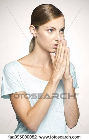 Young woman with hands clasped in prayer View Large Photo Image Stock Image - Young woman with hands clasped in prayer. Fotosearch