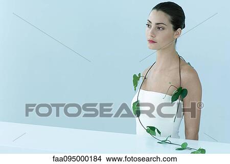 Young woman with leafy vine hanging around shoulders View Large Photo Image Picture - Young woman with leafy vine hanging around shoulders. Fotosearch