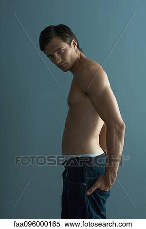 Stock Photography - Barechested man with hands in back pockets. Fotosearch