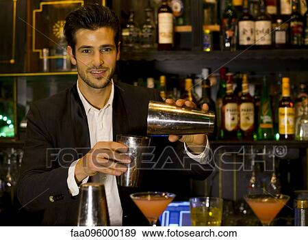 Stock Photo - Bartender preparing cocktail. Fotosearch