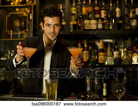 Bartender serving cocktails View Large Photo Image Stock Photo - Bartender serving cocktails. Fotosearch
