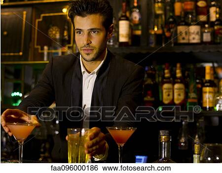 Bartender serving cocktails View Large Photo Image Stock Photograph - Bartender serving cocktails. Fotosearch