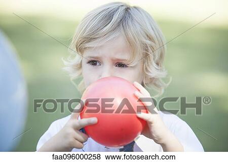 Boy blowing balloon View Large Photo Image Stock Photo - Boy blowing balloon. Fotosearch