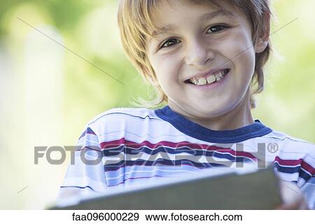 Boy holding digital tablet View Large Photo Image Stock Photo - Boy holding digital tablet. Fotosearch