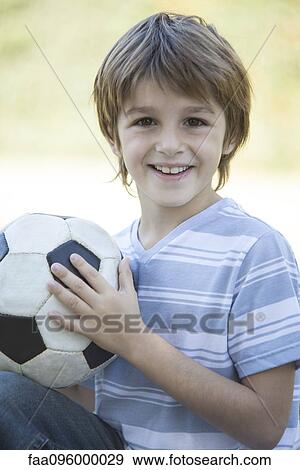 Boy holding soccer ball, portrait View Large Photo Image Stock Photo - Boy holding soccer ball, portrait. Fotosearch