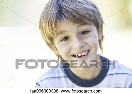 Stock Photo - Boy in striped shirt, portrait. Fotosearch
