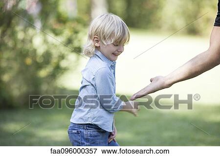 Boy playing with father outdoors View Large Photo Image Stock Photo - Boy playing with father outdoors. Fotosearch