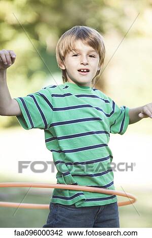 Boy playing with hula hoop View Large Photo Image Stock Image - Boy playing with hula hoop. Fotosearch