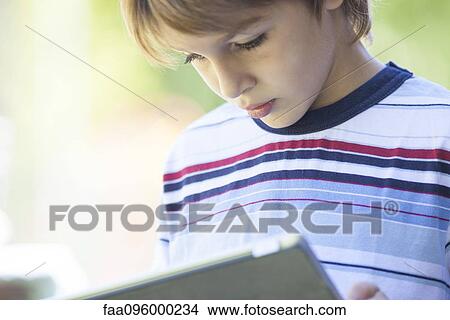 Boy using digital tablet View Large Photo Image Picture - Boy using digital tablet. Fotosearch