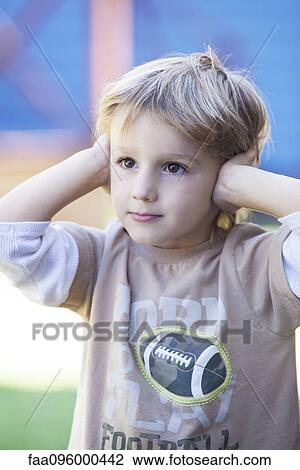 Boy with hands covering ears View Large Photo Image Stock Image - Boy with hands covering ears. Fotosearch