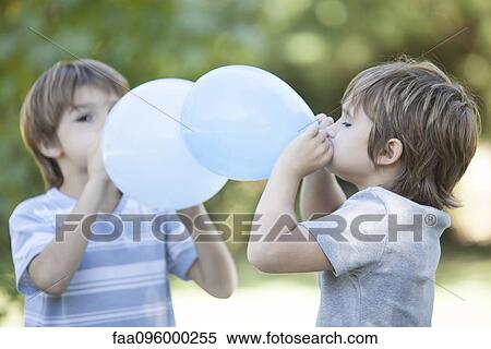 Boys blowing balloons View Large Photo Image Stock Photography - Boys blowing balloons. Fotosearch