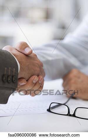 Business deal closed with handshake View Large Photo Image Stock Photograph - Business deal closed with handshake. Fotosearch