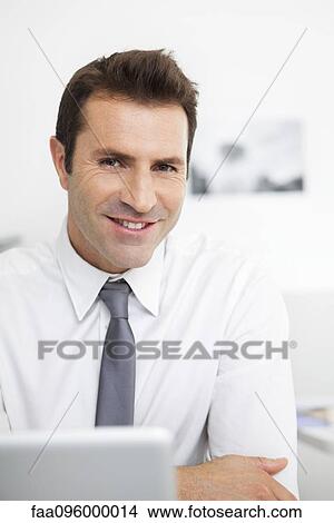 Businessman with laptop computer, portrait View Large Photo Image Picture - Businessman with laptop computer, portrait. Fotosearch