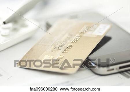 Stock Image - Close-up of credit card and smartphone. Fotosearch