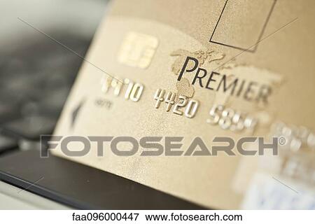 Close-up of credit card resting on computer keyboard View Large Photo Image Stock Photo - Close-up of credit card resting on computer keyboard. Fotosearch