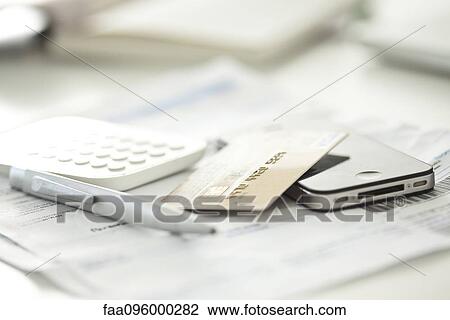 Stock Image - Close-up of credit card with smartphone and calculator. Fotosearch