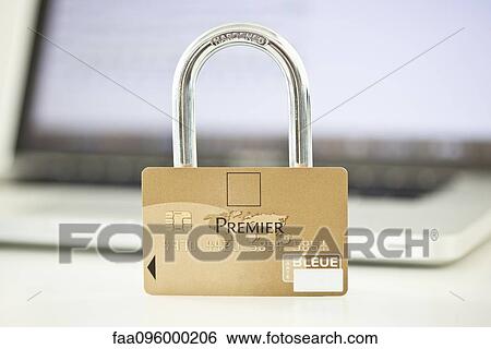 Stock Photograph - Credit card and lock resting on top of laptop computer representing internet security. Fotosearch