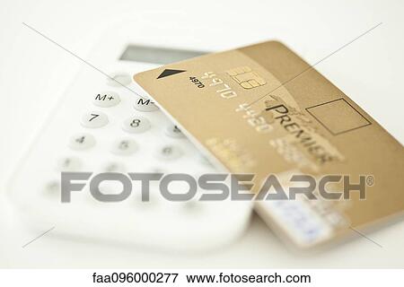 Credit card resting on calculator View Large Photo Image Stock Photo - Credit card resting on calculator. Fotosearch