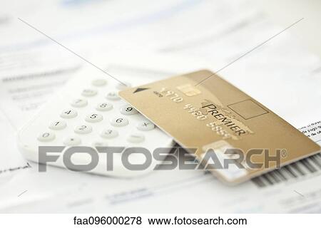 Credit card resting on calculator View Large Photo Image Stock Photo - Credit card resting on calculator. Fotosearch